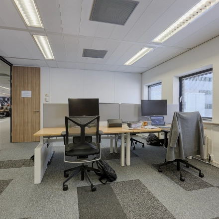 Interior view of a furnished office space with workstations at Patrijsweg 62, ideal for rent office space in Rijswijk. Equipped with desks, chairs, and computers, ready for business activities.