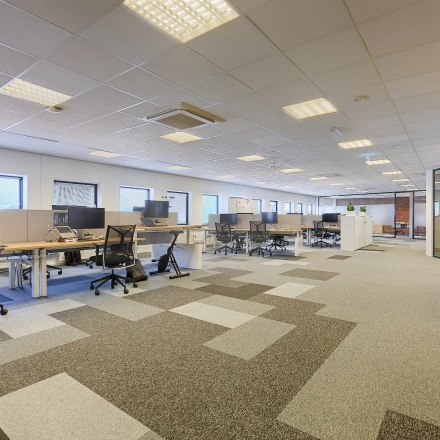 Spacious office to rent at Patrijsweg 62, Rijswijk, featuring multiple desks and chairs, ideal for collaborative work. Bright lighting and large windows enhance the office space rental appeal.