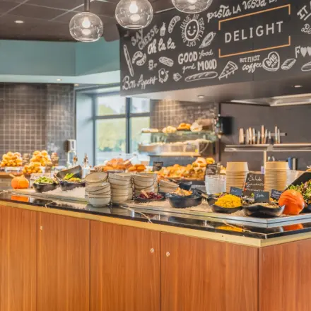 Inviting office pantry area with a buffet of food items, pumpkins, and decorative elements, ideal for a comfortable workspace experience.