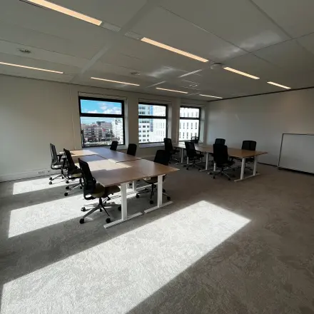 Bright office space with several black office chairs and wooden desks, available for rent at George Hintzenweg 77 - 89, Rotterdam Alexander.