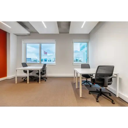 Interior of an office space at Marten Meesweg 25-G, Rotterdam Alexander with desks and chairs facing bright windows. Ideal for office space rental.