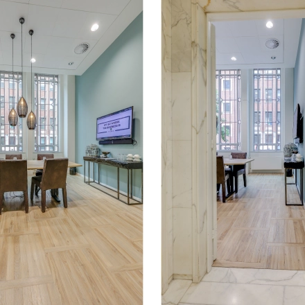 Bright office to rent at Blaak 34, Rotterdam Center features a conference room with a large table, chairs, modern lighting, and a TV. Ideal for office space rental.