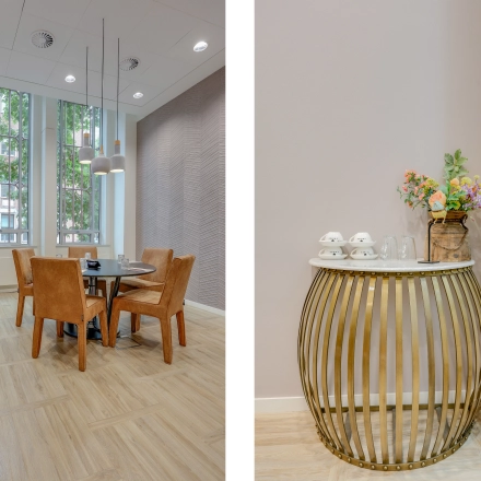 Bright office to rent at Blaak 34, Rotterdam Center, featuring a small furnished meeting area with a round table and leather chairs, complemented by a chic decorative table with coffee amenities.