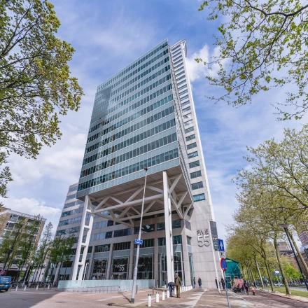 A modern high-rise office building located at Blaak 555 in Rotterdam Center, ideal for those seeking office space rental in the city.