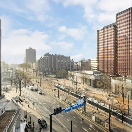 View of the busy urban landscape from an office to rent at Coolsingel 104 in Rotterdam Center, ideal for office space rental.
