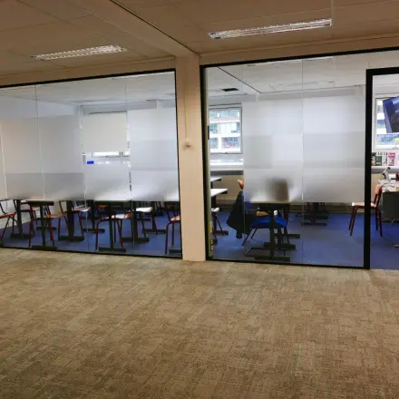 Interior view of an office space available for rent at Wijnhaven 76 in Rotterdam Center, featuring modern workspaces with desks and chairs.
