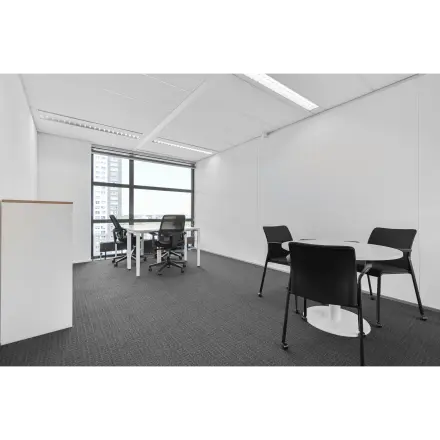 Office space for rent at Weena 290 in Rotterdam Central Station, featuring modern furnishings and large windows for natural light.