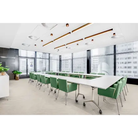 Spacious, well-lit conference room at Weena 505, Rotterdam Central Station with large windows and modern furnishings, ideal for office space rental.