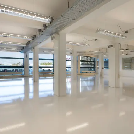 Interior view of a spacious, light-filled office at Lloydstraat 21 B, Rotterdam Delfshaven, available for office space rental. Large windows provide ample natural light.
