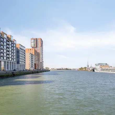 Exterior view of modern office buildings along the waterfront in Rotterdam Delfshaven at Lloydstraat 21 B, ideal for anyone looking to rent office space with a desirable location.
