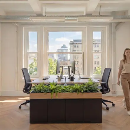 Bright office space at Lloydstraat 5, Rotterdam Delfshaven, featuring desks and ergonomic chairs with a view. Rent office space in this inviting environment.