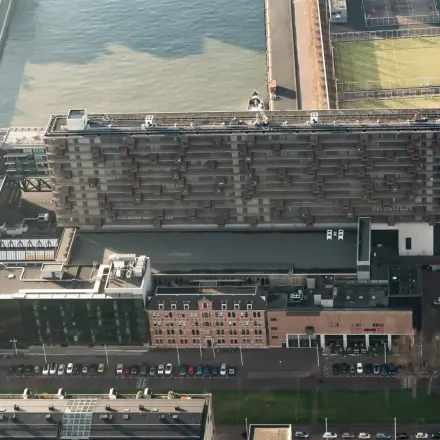 Aerial view of a large, modern office building at Lloydstraat 5, Rotterdam Delfshaven, offering opportunities for office space rental.