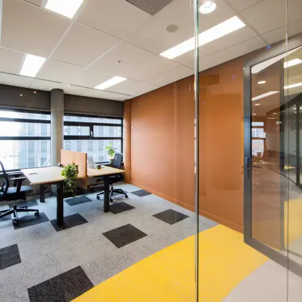 Modern office space for rent at Wilhelminaplein 1-40, Rotterdam Kop van Zuid, featuring large windows, natural light, and contemporary furnishings.