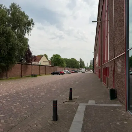 Exterior view of Scheepsbouwweg 29 in Rotterdam Waalhaven, featuring a street scene with cars parked along the side.