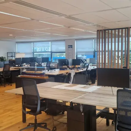 Spacious office space in Rotterdam Waalhaven featuring multiple desks, computers, and plants, ideal for businesses seeking office space rental.