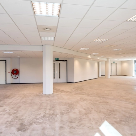 Spacious and unfurnished area at Overschieseweg 304-332, Schiedam. Ideal for office space rental with ample lighting and open layout, ready for customization to fit business needs.
