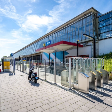 Exterior view of a modern office building located at Overschieseweg 304-332, Schiedam, with a sleek design and clear glass windows, perfect for office space rental.