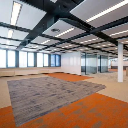 Spacious office space at Schiphol Airport, Folkstoneweg 2-56, featuring open-floor layout with modern lighting and ample natural light. Ideal for those looking for office space rental with customizable possibilities.