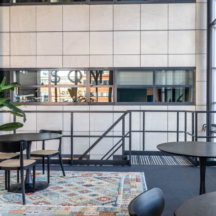 Bright, stylish office space at Beechavenue 54-100, Schiphol Rijk featuring modern furniture, large windows, and plants. Ideal for office space rental.