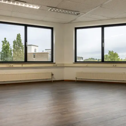 Unfurnished office space with large windows at Curieweg 9, Spijkenisse, available for rent.