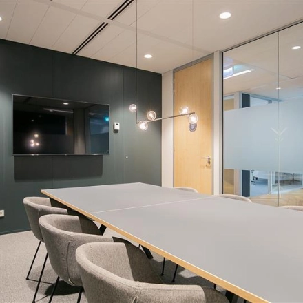 Modern conference room with a sleek table and comfortable chairs at Alexanderveld 5-9, The Hague Center, ideal for flexible office space rental.