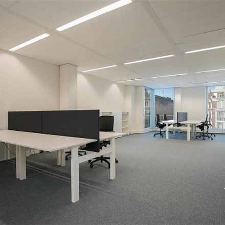 Bright and spacious open office space at Alexanderveld 5-9 in The Hague Center, featuring ample desks and modern ergonomic chairs, available for office space rental.