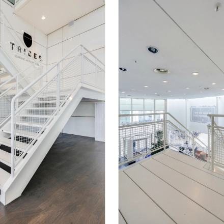 Modern interior view of Kalvermarkt 53, The Hague Center, featuring white staircases and large windows suitable for office space rental.
