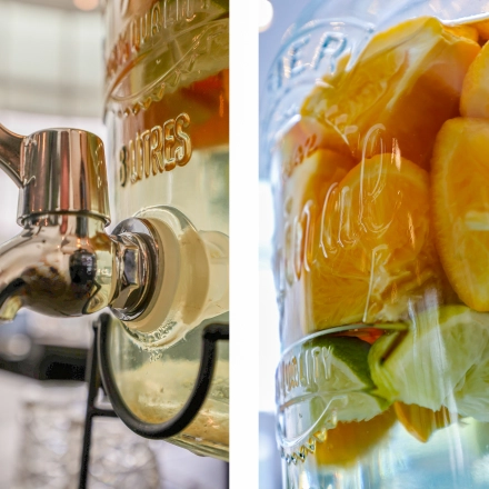 Glass dispenser with citrus-infused water, connected to countertop at Kalvermarkt 53, perfect for office space rental in The Hague Center.