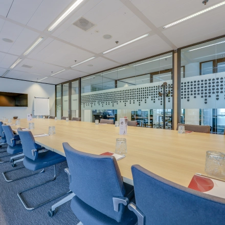 Spacious, well-lit conference room at Kalvermarkt 53, The Hague Center, perfect for office space rental, featuring a large table with comfortable chairs.