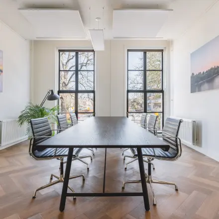 Bright office at Zeestraat 100, The Hague Center, featuring large windows, a sleek table, and stylish chairs. Perfect spot for your next office space rental.
