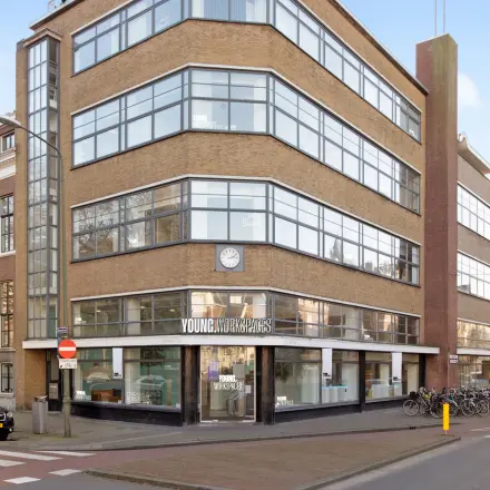 Exterior view of an office building for rent at Zeestraat 100, The Hague Center, showing a modern facade with large windows.