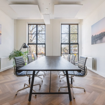 Bright, furnished office space with a long table and chairs, perfect for an office space rental in The Hague Center.