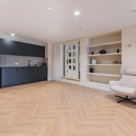 Modern office space at Zeestraat 100, The Hague Center, featuring a sleek kitchen area and stylish shelves, ideal for office space rental.