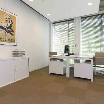Bright office space with two desks, chairs, and cabinets in The Hague's Statenkwartier area. Ideal for those seeking office space rental with a professional and modern touch.