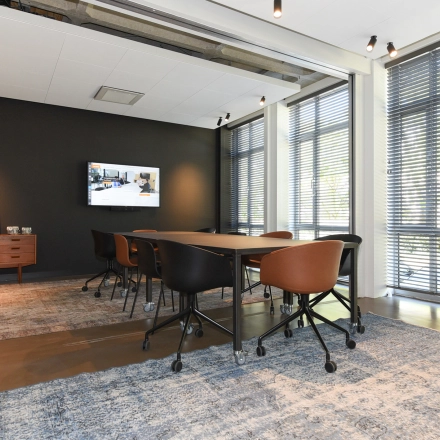 Furnished conference room with a large table and chairs, suitable for office space rental at President Kennedylaan 19, The Hague Statenkwartier.