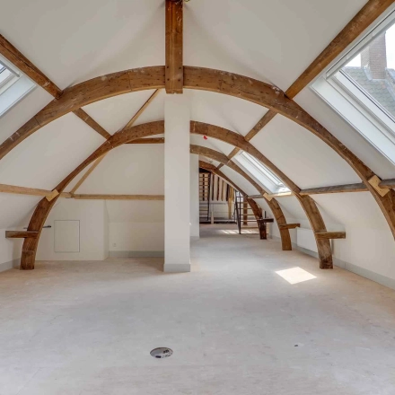 Spacious attic office space with wooden beams and skylights at Brigittenstraat 22, Utrecht Center, ideal for unique office space rental.