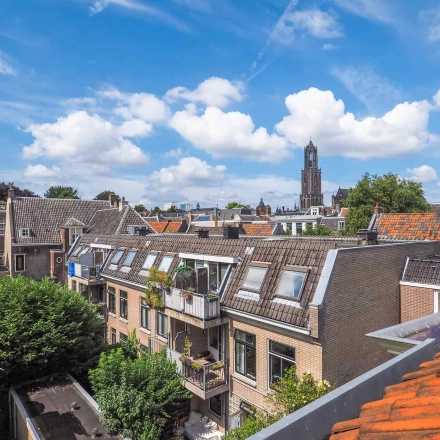 A picturesque view of buildings and rooftops in Utrecht Center, showcasing potential office to rent. The iconic tower provides a scenic backdrop for this office space rental option.