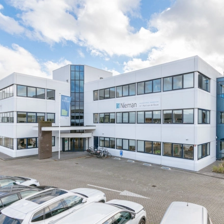 Exterior view of the office building at Atoomweg 350 in Utrecht Lage Weide, showcasing the entrance and parking area.