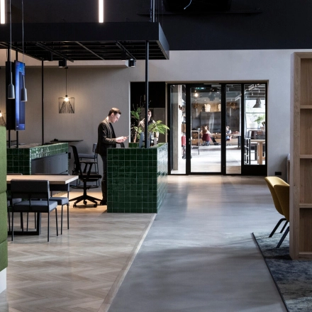 Stylish office space at Atoomweg 63, Utrecht Lage Weide, featuring a modern interior with people engaged in business activities. Ideal for office space rental with contemporary furnishings and functional design.