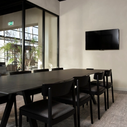 Conference room available for office space rental at Atoomweg 63, Utrecht Lage Weide, featuring a sleek meeting table, chairs, and a wall-mounted TV.