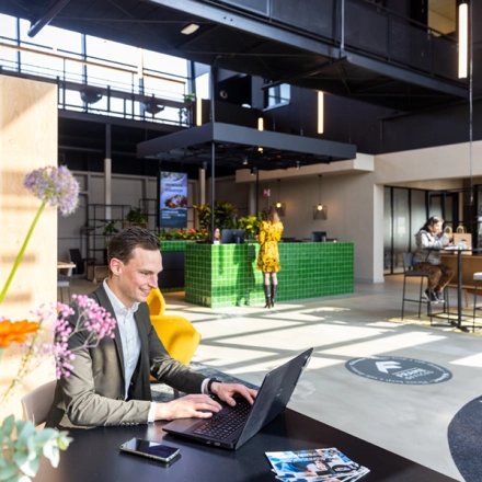 Modern office space for rent at Atoomweg 63, Utrecht Lage Weide, featuring bright, open workspaces with people engaged in various business activities.