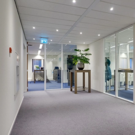 Modern office space at Atoomweg 63, Utrecht Lage Weide, featuring a clean, furnished interior with glass partitions and plants. Ideal for office space rental.