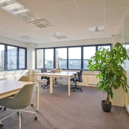 Bright furnished office space at Kobaltweg 11, Utrecht Lage Weide, featuring modern desks and chairs with large windows providing natural light.