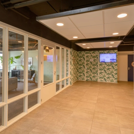 Entrance area with tiled flooring and large windows, leading to office spaces available for rent at Utrecht Lage Weide on Reactorweg 301.