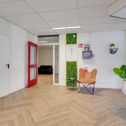 Bright office interior at Zonnebaan 18, Utrecht Lage Weide with wooden flooring, modern decor, and seating area, available for office space rental.