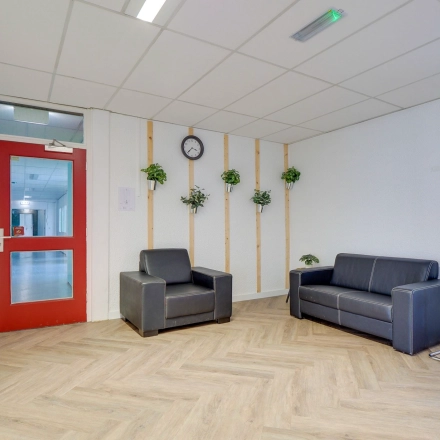Office lounge area at Zonnebaan 18, Utrecht Lage Weide, featuring seating and decorative plants, perfect for office space rental.