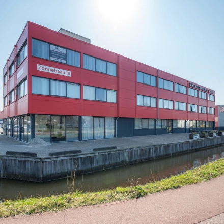 Exterior view of the red office building located at Zonnebaan 18, Utrecht Lage Weide, offering office space rental opportunities.