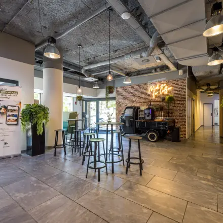 Vibrant interior space at Goeman Borgesiuslaan 77, Utrecht North, ideal for office space rental with modern decor and ample seating.