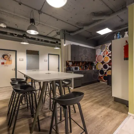 Modern furnished office space at Goeman Borgesiuslaan 77, Utrecht North, featuring stylish seating and vibrant wall art. Ideal for an office space rental or office to rent opportunity.