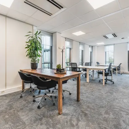 Interior view of a furnished office at Orteliuslaan 850, Utrecht Papendorp, featuring multiple desks and chairs, available for office space rental.